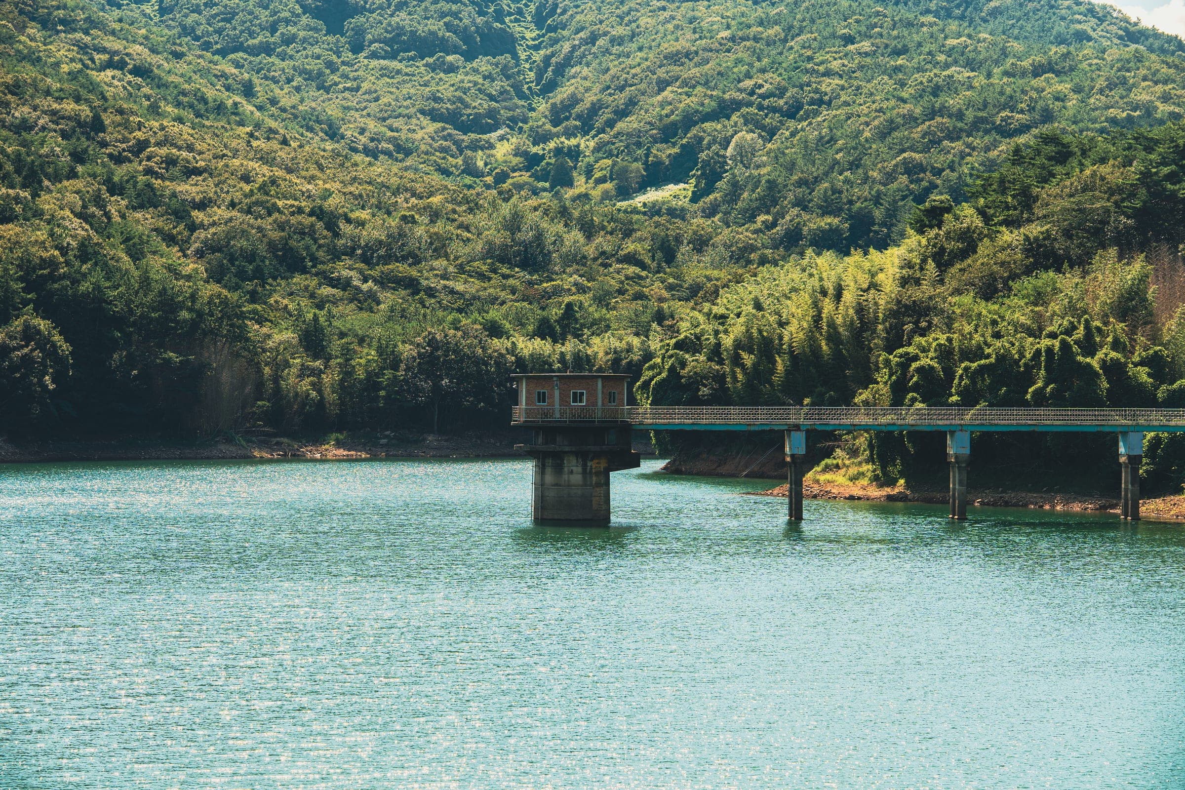 Reservoir under green hills
