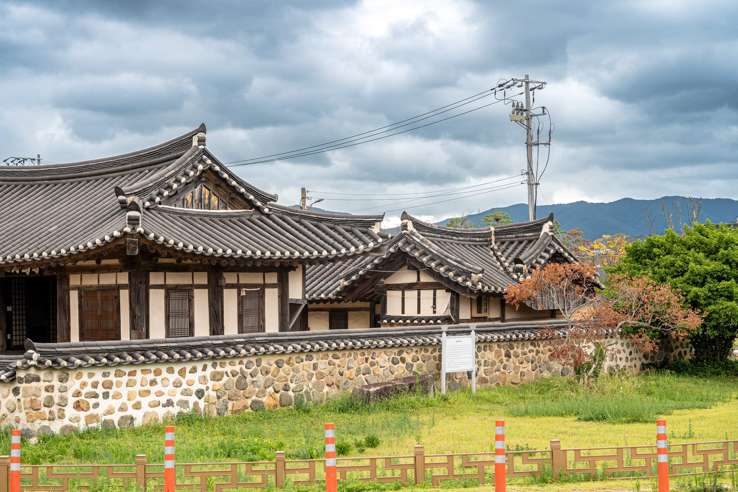 Hanok houses behind the stone wall